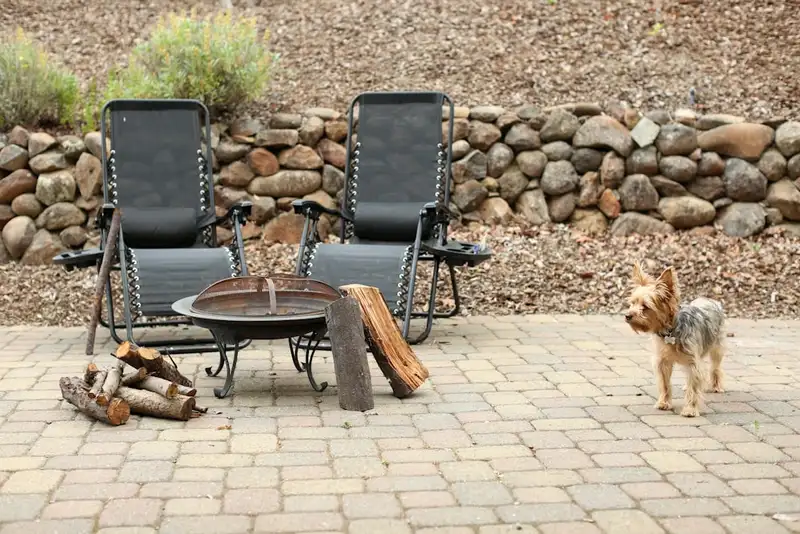 Backyard paver patio with a fire pit